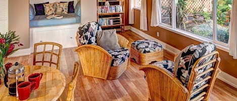 Light filled living room, dining area and cozy reading nook