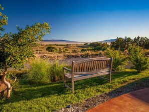 Teak bench in front of the cottage with expansive views of the three mountains