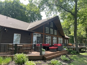 Lakeside view of cabin with expansive deck for family fun