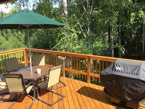 Deck with seating for 9 and grill.