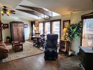 The 2nd living area with a massage chair, woodstove, game table, &reclining sofa