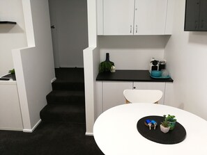 Dining hub and relaxing lounge area, with stairs to the kitchenette and bathroom