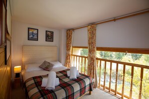 Bright double bedroom with a river side view