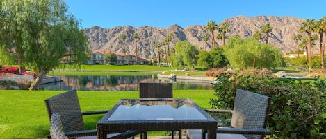 Outdoor patio dining and seating with views of the lake and mountains