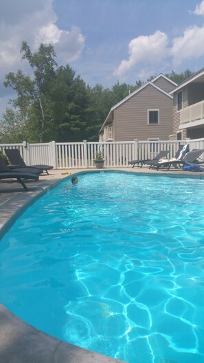 Seasonal Pool behind other building with Mountain Views. 