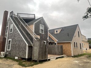 Rear view: West wing with roof deck, outdoor shower, and East wing