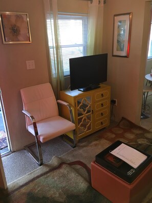 Bold TV console with 32 inch flatscreen and ombré curtains.