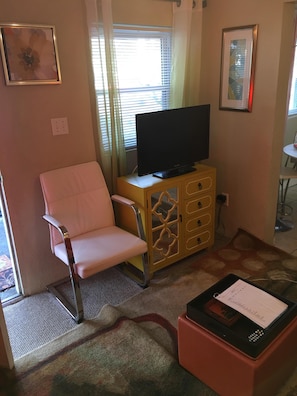 Bold TV console with 32 inch flatscreen and ombré curtains.