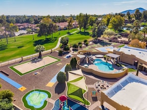 [Backyard] with heated pool and spa, splashpad, volleyball, basketball, mini golf, and more