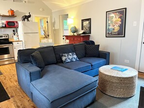 view of main living space with sectional pull out couch and TV 