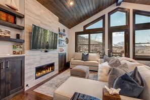 Living Room with Plush Contemporary Furnishings, 55" LG Smart TV, Gas Fireplace, Deck Access with a Private Hot Tub, and Breathtaking Deer Valley Views