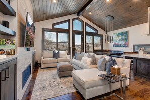 Living Room with Plush Contemporary Furnishings, 55" LG Smart TV, Gas Fireplace, Deck Access with a Private Hot Tub, and Breathtaking Deer Valley Views