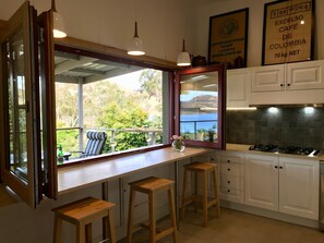 Kitchen’s Breakfast bar with bifold windows towards verandah