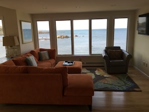 Oceanfront living room with updated furnishings and flatscreen HDTV.