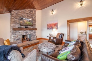 Great Room with Leather Furniture, Stacked Stone Fireplace, and HD Smart TV