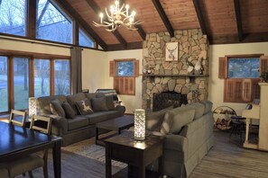 The great room with working fireplace and gorgeous views from the large windows