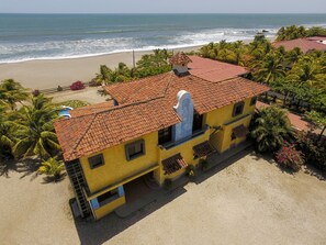 Aerial view of house from the parking lot towards the ocean