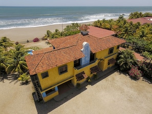 Aerial view of house from the parking lot towards the ocean