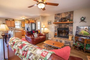 Living Room with Leather Sofa, HDTV, and Wood-burning Fireplace