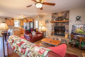 Living Room with Leather Sofa, HDTV, and Wood-burning Fireplace