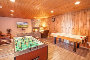 Lower Level Game Room and Den with Tongue-in-Groove Ceiling and Accent Wall