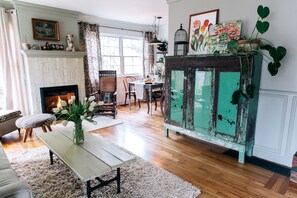 Living room with fire place and hidden tv inside green hutch:)