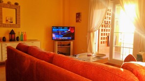Large fully furnished lounge with excellent sunsets coming through the window.