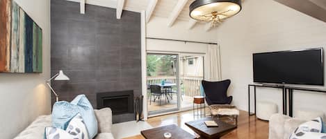 Living room with access to deck and BBQ Backs up to Dollar Mountain. 