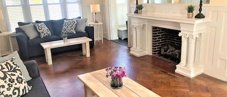 Large turn of century fireplace and connecting doors to sun room!