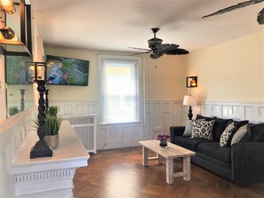 Living room area with flat screen and two large couches!