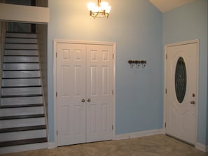 Foyer with closet and stairs to 2 bedrooms and full bath upstairs.  