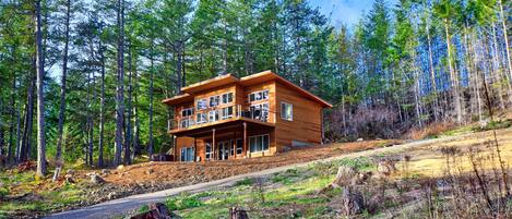 Northwest Modern design with cedar siding, perched on the hillside.