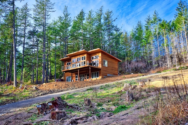 Northwest Modern design with cedar siding, perched on the hillside.