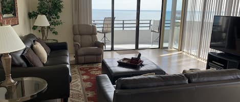 Living area with balcony doors facing east and wrapping to the south side.  