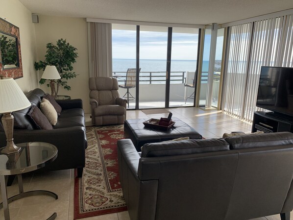 Living area with balcony doors facing east and wrapping to the south side.  