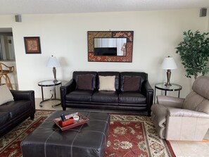 New leather sofa & love seat set, single recliner, and a large ottoman.