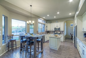 Open floor plan and large windows along back of home create naturally bright living spaces.
