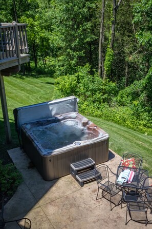 Outdoor hot tub with entertaining patio