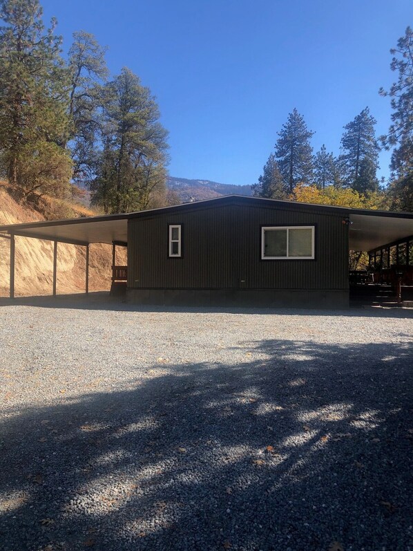 Entry to property, Carport, and Front deck with view of the Mountains and Pines 