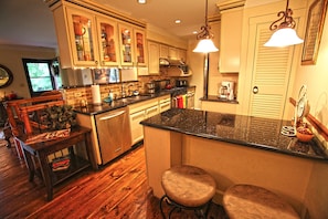 Kitchen with granite counter tops, 6 burner stove, stool seating for 4 and dinin