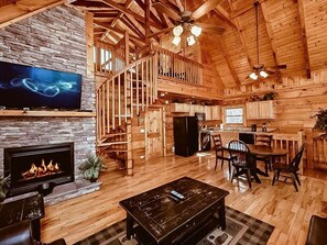 Main level living room with flat screen tv and fireplace