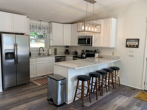 Newly Renovated Kitchen with Stainless Appliances, Quartz Tops & New Cabinets.