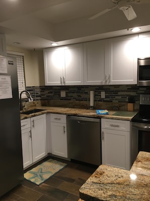 Full service kitchen with stainless appliances.