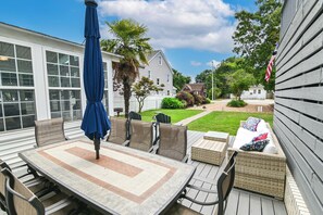 large patio with dining table and separate sitting area