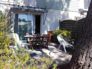 This is your terrace with sun beds, dining set, parasol and vine covered arbour.