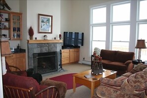 Great room with wood burning fireplace and a 50" High-Def Plasma TV