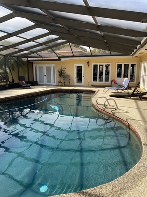 Screened heated pool with plenty of room outdoors.