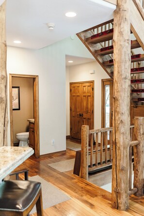 Entry way from the garage and front door and main floor powder room. 