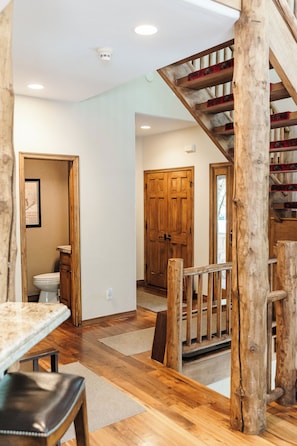 Entry way from the garage and front door and main floor powder room.