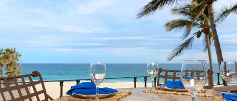 Ocean view from oversized balcony with chaise loungers and gas grill